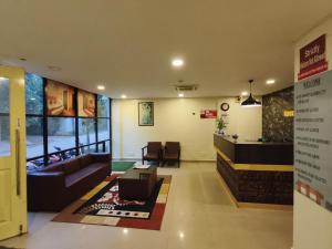 a lobby with a couch and a waiting room at Apex Inn Manyata in Bangalore