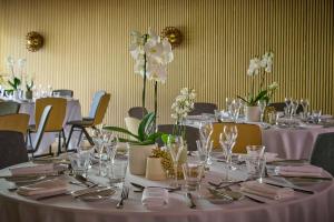 a set of tables with silverware and flowers on them at Hyatt Centric Cambridge in Cambridge