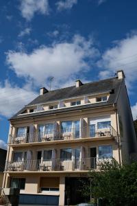 a building with balconies on the side of it at Louis Hotel in Perros-Guirec