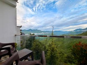 a balcony with a view of the mountains at Pine View Luxury Resort With Mountain View & Premium Rooms Mussoorie in Mussoorie