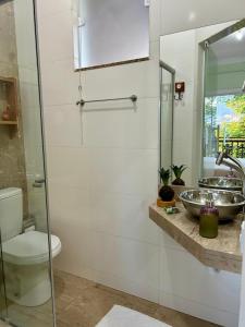 a bathroom with a toilet and a sink at Pousada Canto do Luar in Conceição do Mato Dentro