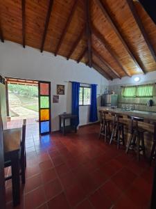 a kitchen with wooden tables and chairs in a room at Hotel Cristo Rey Campestre in Los Santos