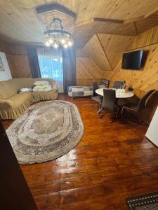 a living room with a couch and a table at Berizka in Yaremche