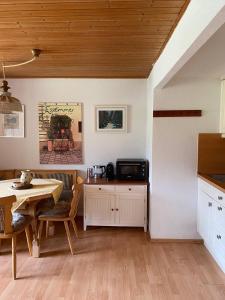 a kitchen with a table and a dining room at Haus Wäscher in Hirschegg