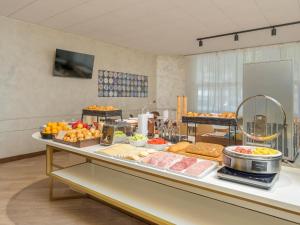 a buffet of food on a table in a room at B&B Hotel Como City Center in Como +38 photos