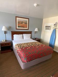 a hotel room with a large bed and two night stands at Relax Inn in Brunswick