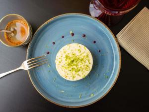a blue bowl of food with a fork on a table at Hotel Mercure Porto Gaia in Vila Nova de Gaia