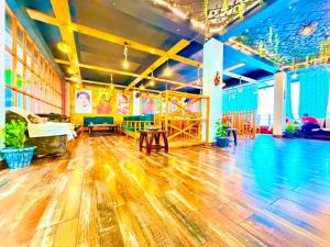 a large room with a wooden floor and wooden tables at Pine View Luxury Resort With Mountain View & Premium Rooms Mussoorie in Mussoorie