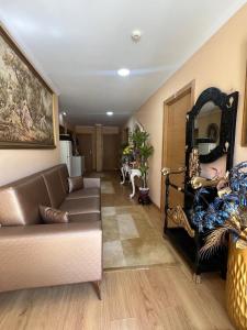 a living room with a couch and a mirror at Casa Dourado Ramos in Vila do Conde