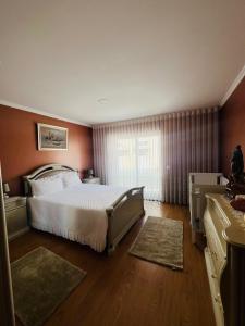 a bedroom with a large bed and a window at Casa Dourado Ramos in Vila do Conde