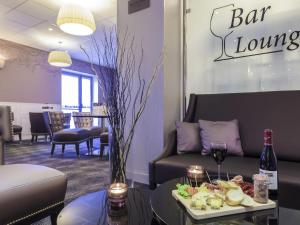 a bar lounge with a table with a tray of food at Mercure Tours Centre Gare et Congrès in Tours