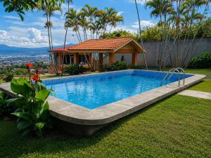 a swimming pool in the yard of a house at Hotel Monte Campana Escazu in San José