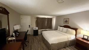 a hotel room with a bed and a desk at Coachman Inn in Kittery