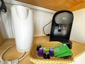 a coffee maker sitting on a counter next to a blender at Studio Cosy & Chic in Angoulême