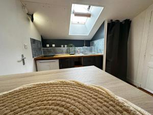 a kitchen with a wooden table and a sink at Studio Cosy & Chic in Angoulême