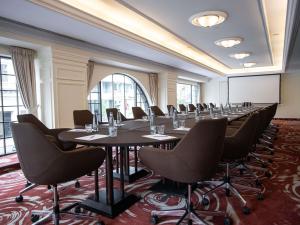 a conference room with a long table and chairs at Mövenpick Hotel Budapest Centre in Budapest