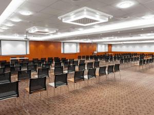 an empty lecture hall with chairs in it at Mövenpick Hotel Budapest Centre in Budapest