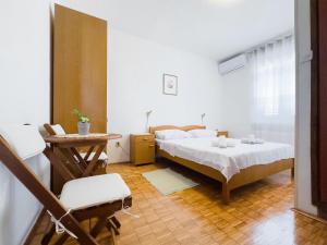 a bedroom with a bed and a table and a chair at Bed&Breakfast Drage in Drage