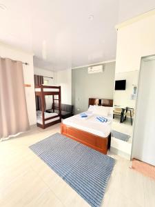 a bedroom with a bed and a blue rug at Olliz Huvila in Siquijor