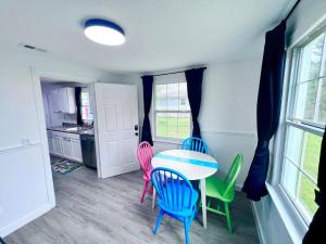 a dining room with a table and four chairs at Saint Augustine 3BR PetFriendly Fenced Backyard in St. Augustine