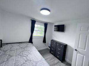 a bedroom with a bed and a window and a dresser at Saint Augustine 3BR PetFriendly Fenced Backyard in St. Augustine