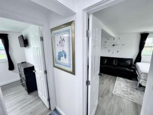 a room with a hallway with a living room with a couch at Saint Augustine 3BR PetFriendly Fenced Backyard in St. Augustine