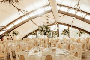 a banquet hall with white tables and white chairs at Hanul Moara cu Noroc in Ineu