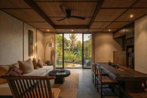 a living room with a couch and a table at SHIBUMI - Private Pool & Spa Boutique Villa in Ubud