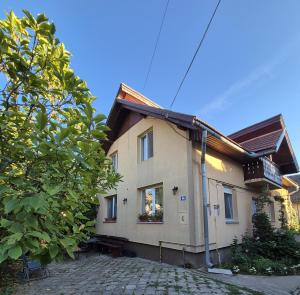 a house with a window on a cobblestone street at PENSIUNEA BIO in Coltău +13 photos