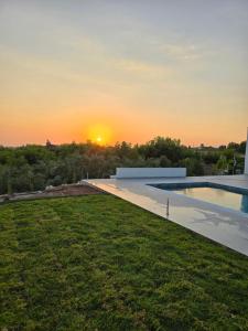 a view of the sunset from the backyard of a house at Elia Serenity House in Anarita +8 photos