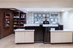 a man sitting at a counter in a library at Garner Hotel Macon West by IHG in Macon +70 photos