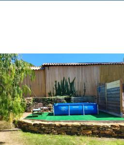 a backyard with a pool and a ping pong table at Le Colibri in La Ciotat