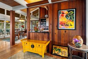 a room with a table and a picture on the wall at Orchid Hale in Kailua-Kona