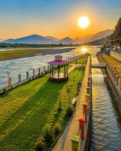 a view of a river at sunset at Galiyat City hotel in Mingāora