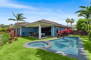 a house with a swimming pool in the yard at Holua Kai 21 in Kailua-Kona