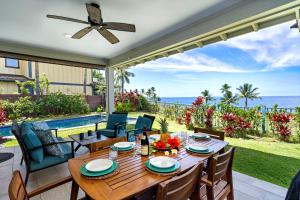 a dining room with a table and a view of the ocean at Holua Kai 21 in Kailua-Kona