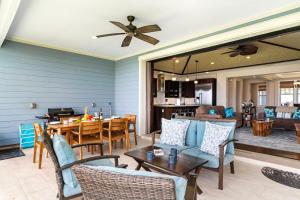 a living room with a table and chairs at Holua Kai 21 in Kailua-Kona
