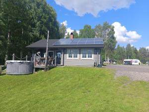 a small house with solar panels on the roof at Arctic Camping Finland in Pello