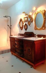 a bathroom with a wooden vanity and a mirror at Casa Antik in Loja +10 photos