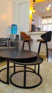 a coffee table in a living room with a couch and chairs at Vito Haven suites in Busia