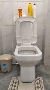 a bathroom with a white toilet in a room at Vito Haven suites in Busia +18 photos