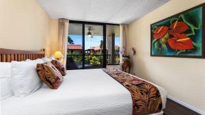 a bedroom with a large white bed with a large window at Kona Pacific C520. in Kailua-Kona