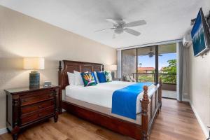 a bedroom with a bed and a window at Kona Pacific D622 in Kailua-Kona