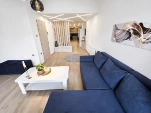 a living room with a blue couch and a table at Adriana Luxury Studio in Kastoria +20 photos