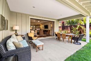 a patio with a couch and chairs and a table at Holua Kai 37 in Kailua-Kona