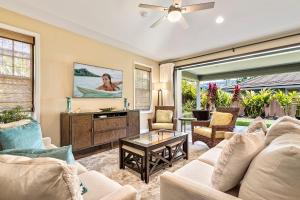 a living room with a couch and a table at Holua Kai 37 in Kailua-Kona