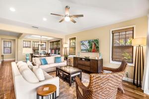 a living room with a white couch and chairs at Holua Kai 37 in Kailua-Kona +28 photos
