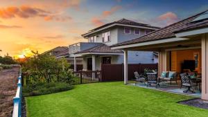 a house with a yard with green grass at Holua Kai 6 in Kailua-Kona +46 photos