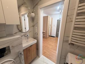 a small bathroom with a sink and a mirror at Apartament Olimpia in Lębork +16 photos