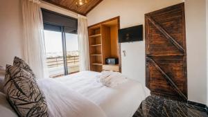 a bedroom with a bed and a large window at Hotel Paradise KMA in Bouznika +38 photos